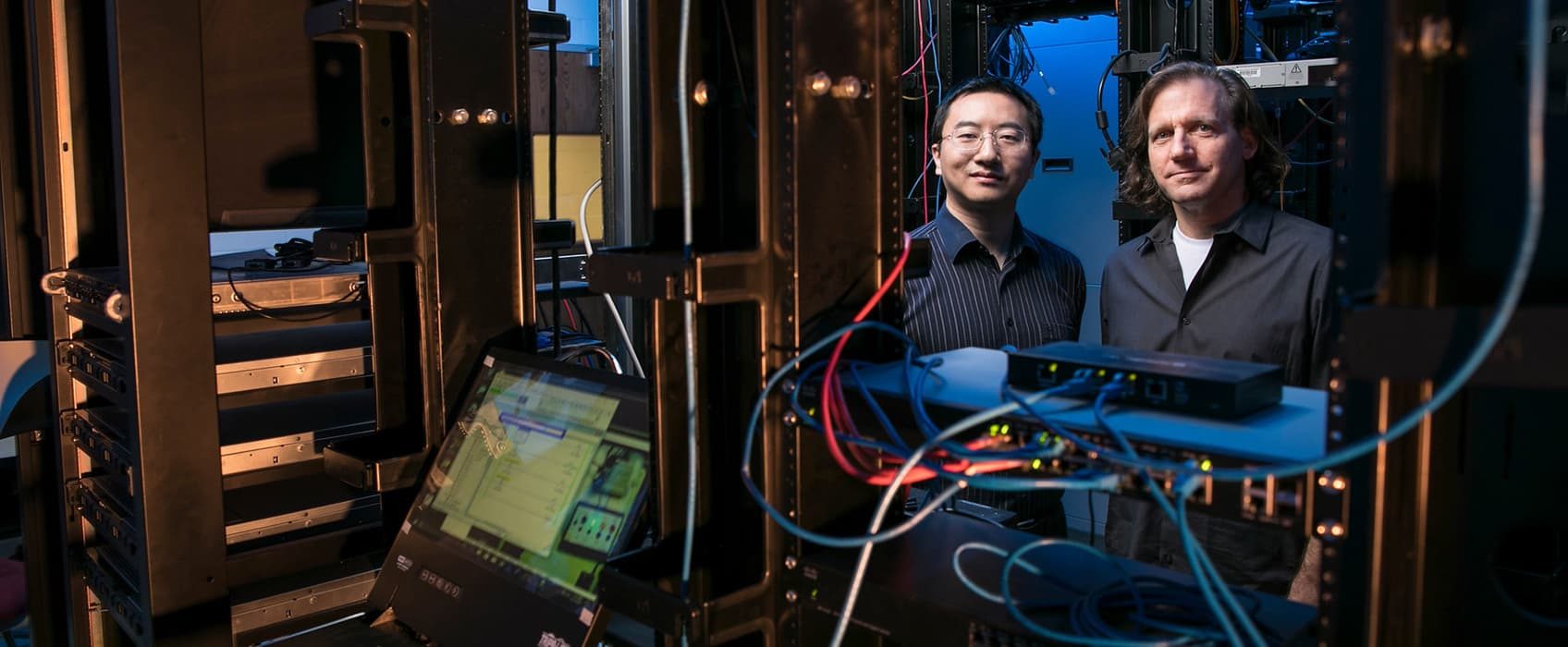 Jim Jones, Associate Professor, MS Computer Forensics, Electrical and Computer Engineering and Kai Zeng, Assistant Professor, Cyber Security, Electrical and Computer Engineering at the Cyber Physical Lab. Photo by: Ron Aira/Creative Services/George Mason University
